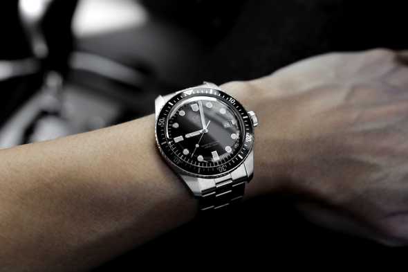 A wristwatch on a man's wrist.